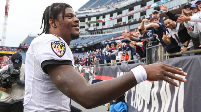 Lamar Jackson greets fans in the stands